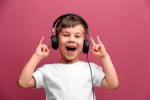young kid wearing white shirt and headphones